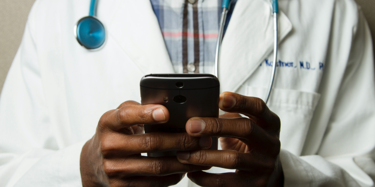 Medical professional conveying health communications on a smartphone